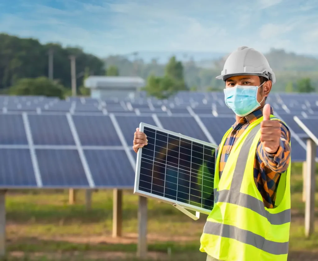 engineer thumbs up and holding solar panel