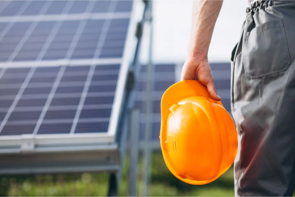 engineer holding helmet in hand